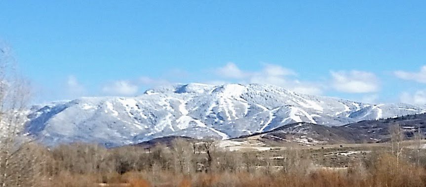 Snow-capped Mountains Against Clear Blue Sky Scene.jpg