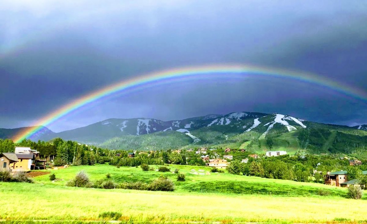 Vibrant Rainbow Over Mountain Valley Capture.jpg