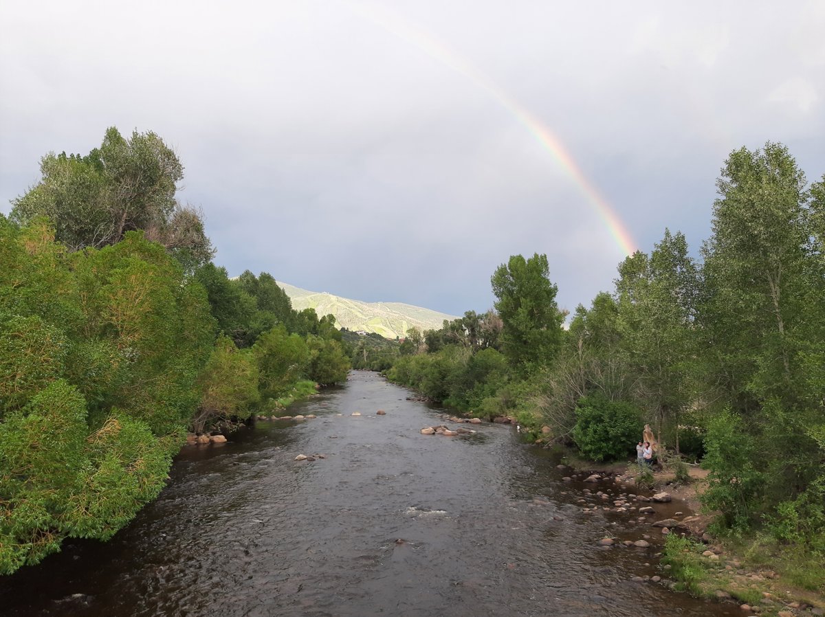 Rainbow Over Serene River Lakeside Landscape Panorama.jpg
