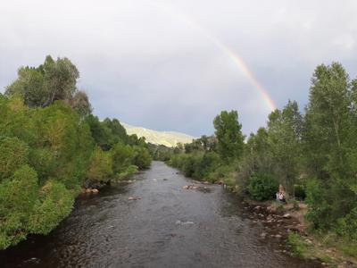 Rainbow Over Serene River Lakeside Landscape Panorama.jpg